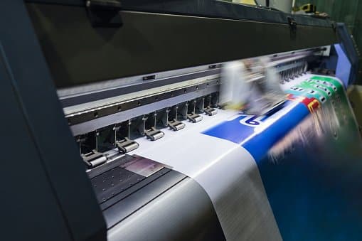 Industrial label printing press running a wide web of color-printed labels